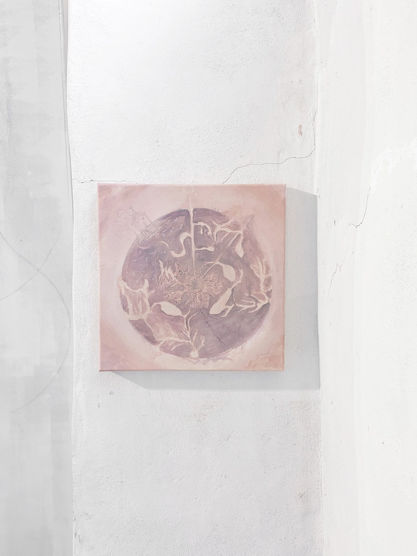 Angelika Puff, Planet 2, a small round-composition canvas in bruised rose and cream showing tangled botanical and figural forms, hung on a cracked whitewashed pillar.
