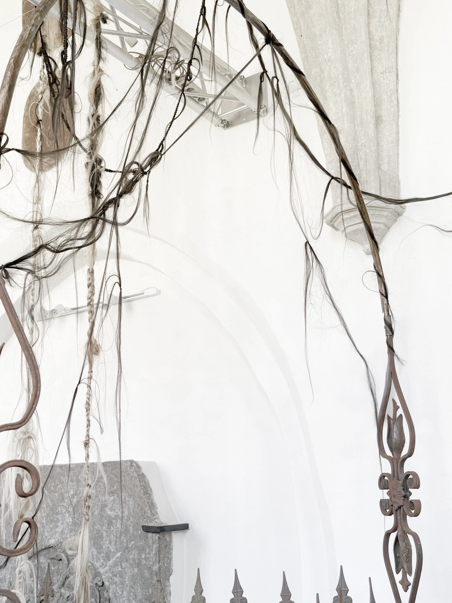 Angelika Puff, Bird Cage, 2025 — angled view of full sculptural installation showing hair cascade from metal structure in Galeria EL Gothic interior.