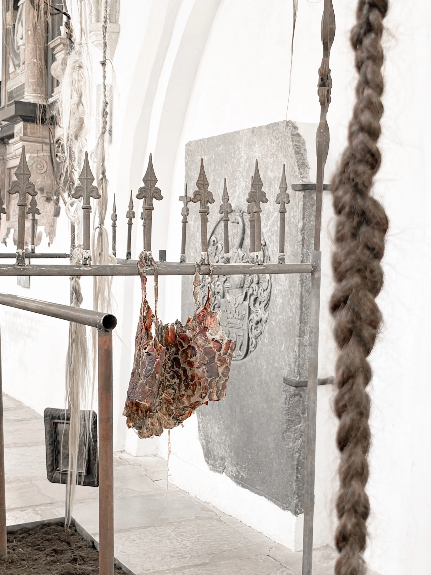Angelika Puff, Bird Cage, 2025 — atmospheric view with hair casting long shadows on the white church wall below vaulted ceiling.