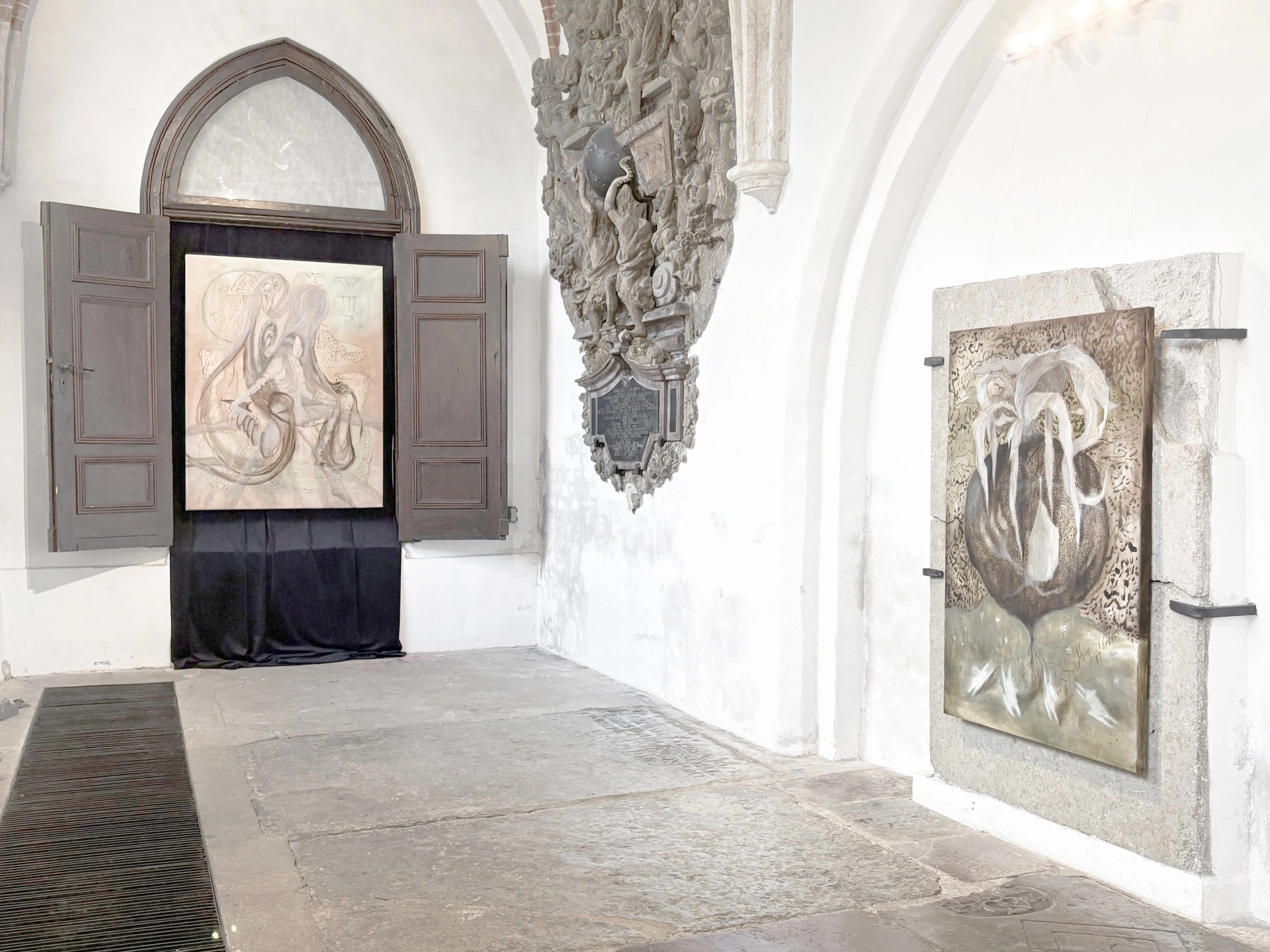 Angelika Puff, two pale oil paintings hung inside a wooden portal and on a granite slab beside a carved Baroque epitaph in Galeria EL, Hairline installation view.