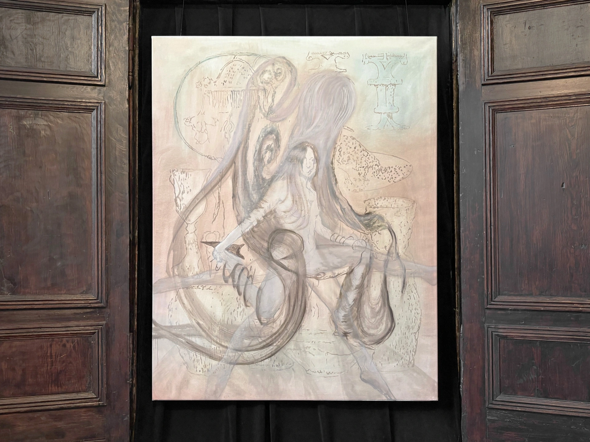 Angelika Puff, Zveny Gor, an ivory-toned oil painting of a seated woman whose unspooling hair coils into serpentine forms over faint diagrammatic marks, framed in dark wooden doors.