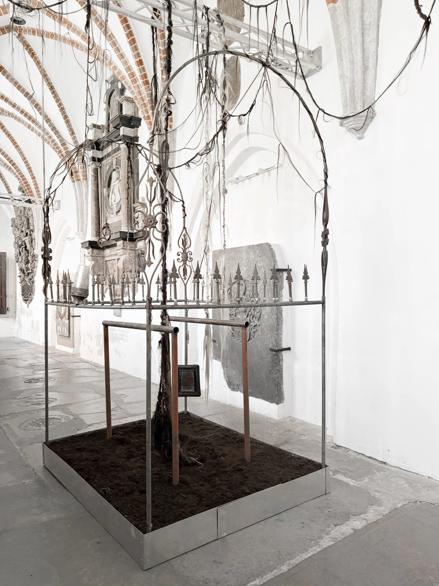 Angelika Puff, Bird Cage, 2025 — wide compositional view showing the cage in Galeria EL with stone floor and arched windows.
