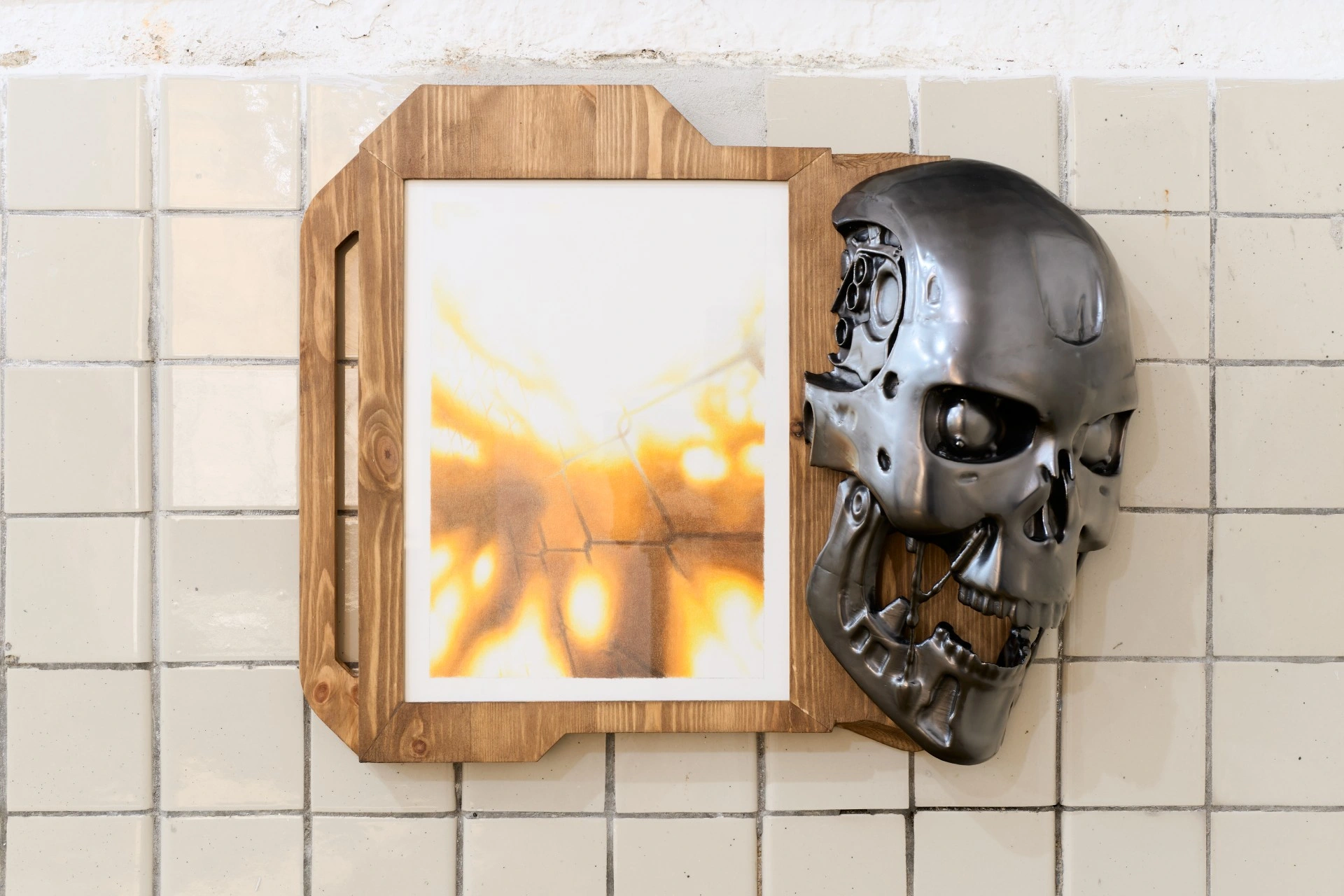 Tristan Gac, framed pencil drawing of burning fence with a chrome T-800 skull, hydraulic jaw and cranial detail, cast into pine board