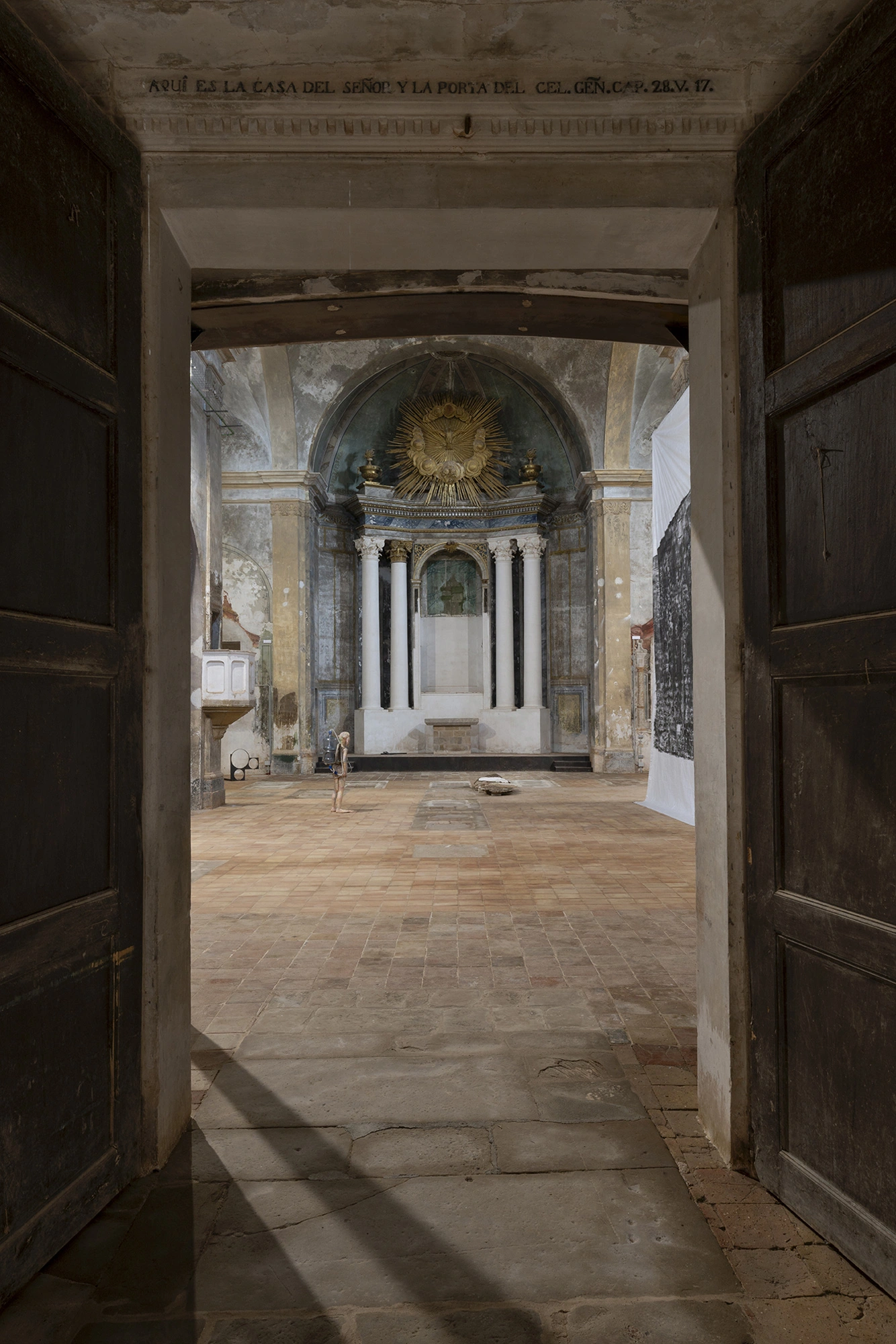 Installation view of KIN TOO looking down the nave of the Church of Sant Feliu, Lladó.