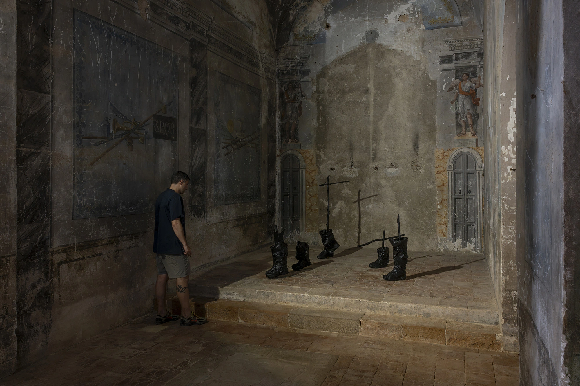 A visitor in the side chapel of the Church of Sant Feliu, Lladó, before Sahatsa Jauregi's Pájaros.