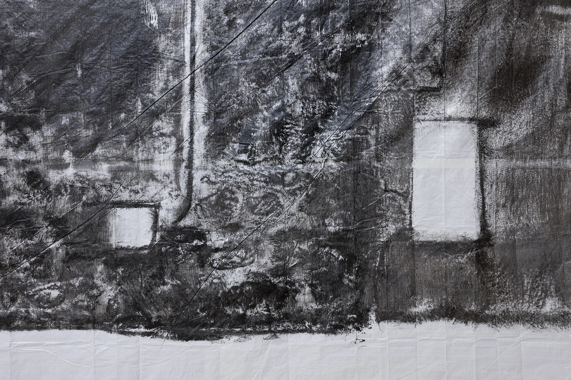 Detail of the rubbed surface of Andrew Birk's Floating House, the stone coursing transferred in dense black onto white sheeting.