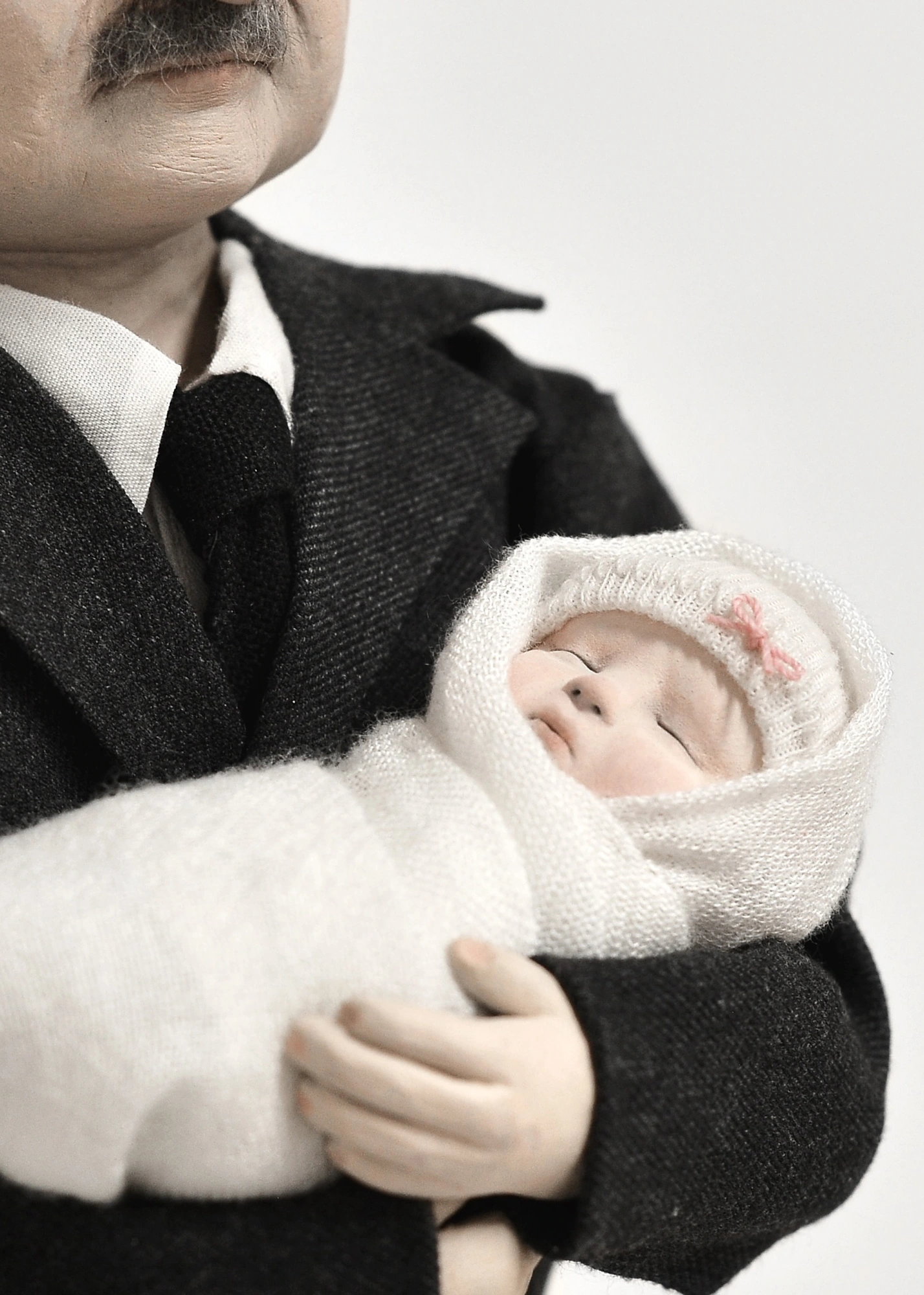 Alicia Bilbao, Heidegger and Being, 2026, detail of the figure holding an infant. Epoxy clay, fabric, dog hair, resin, wood, oil paint