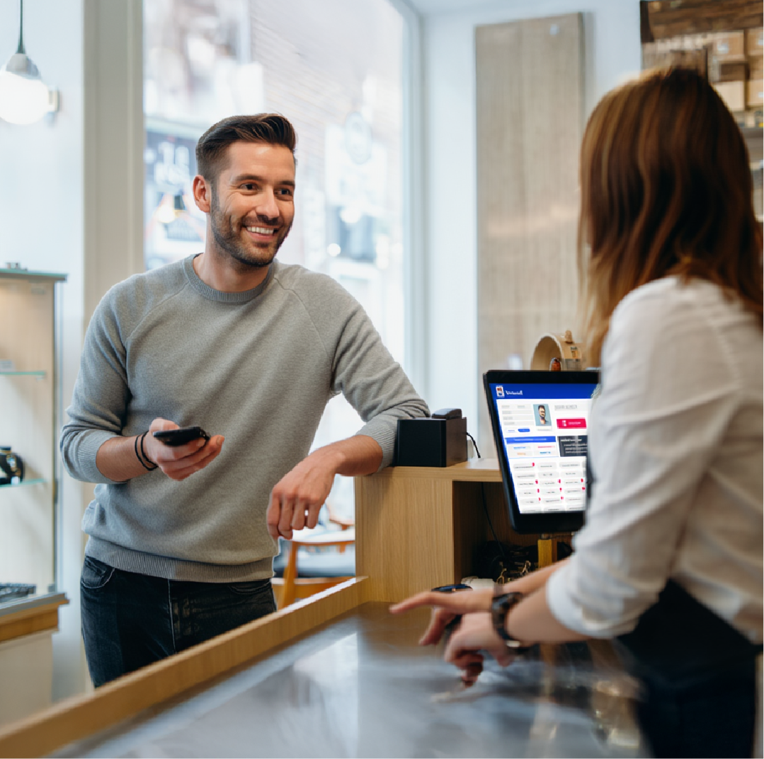 A man in retail store using rewards app
