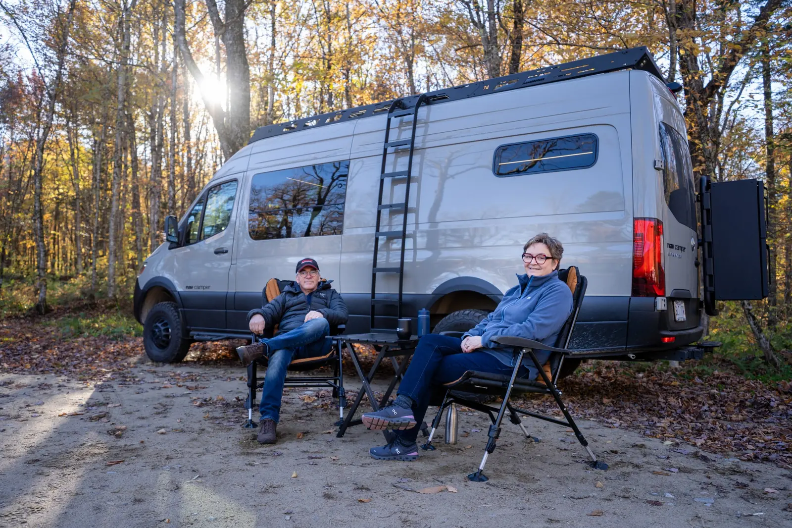Owners in front of their Nav Camper ONYX camper van at Base Camp