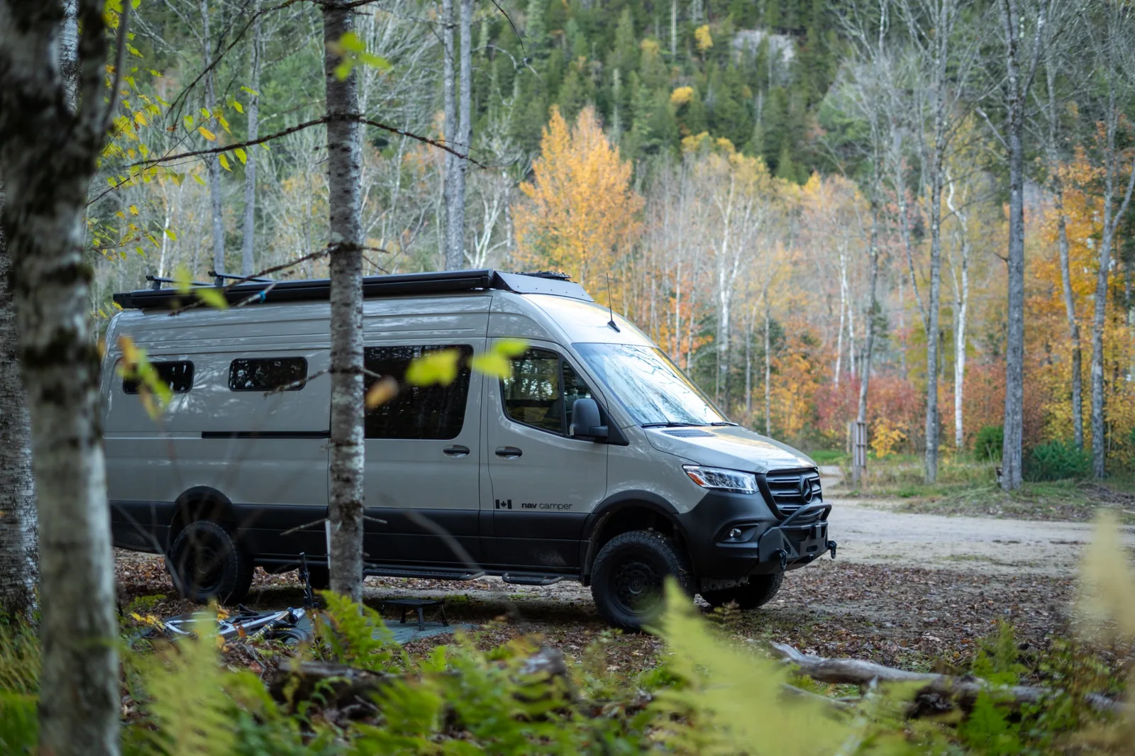 Nav Camper Sprinter camper van in an autumn forest