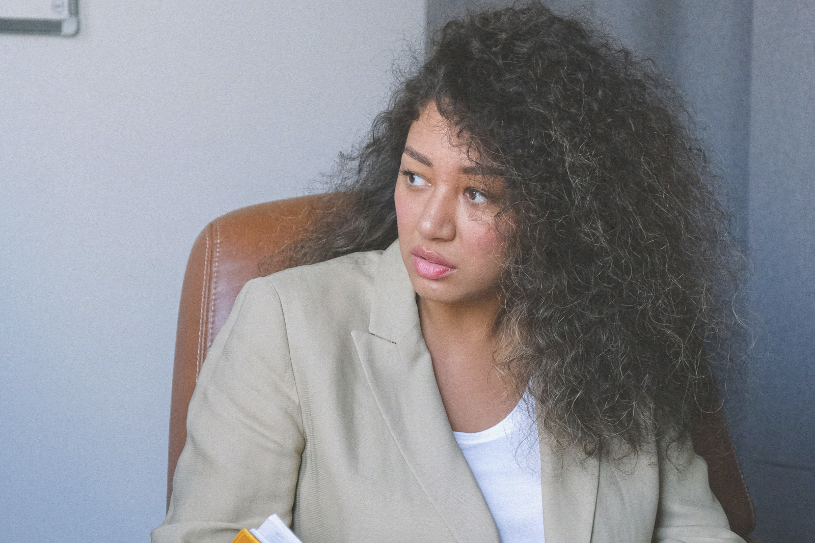 woman staring off from book