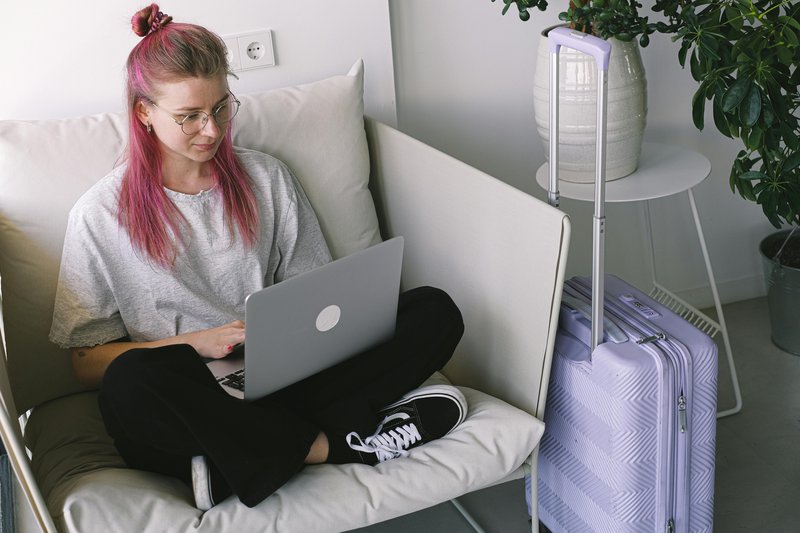 Traveller browsing hotel options on a laptop — most guests begin their search on OTAs before visiting the hotel website directly
