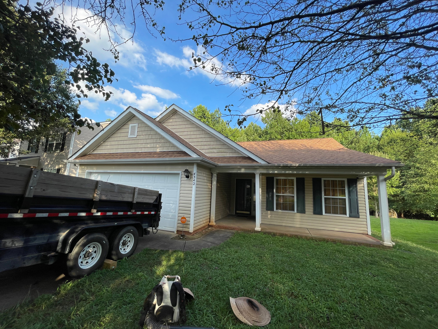 House with a trailer in the driveway.