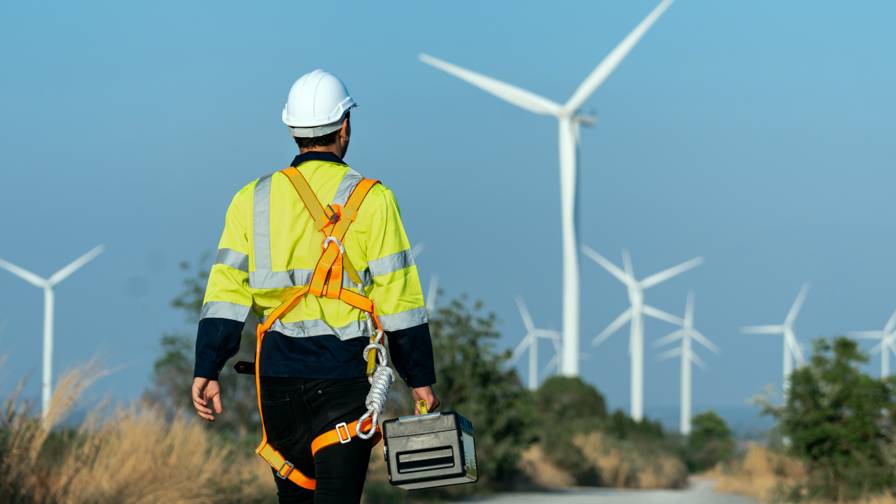 A relevant operator walking towards a wind farm