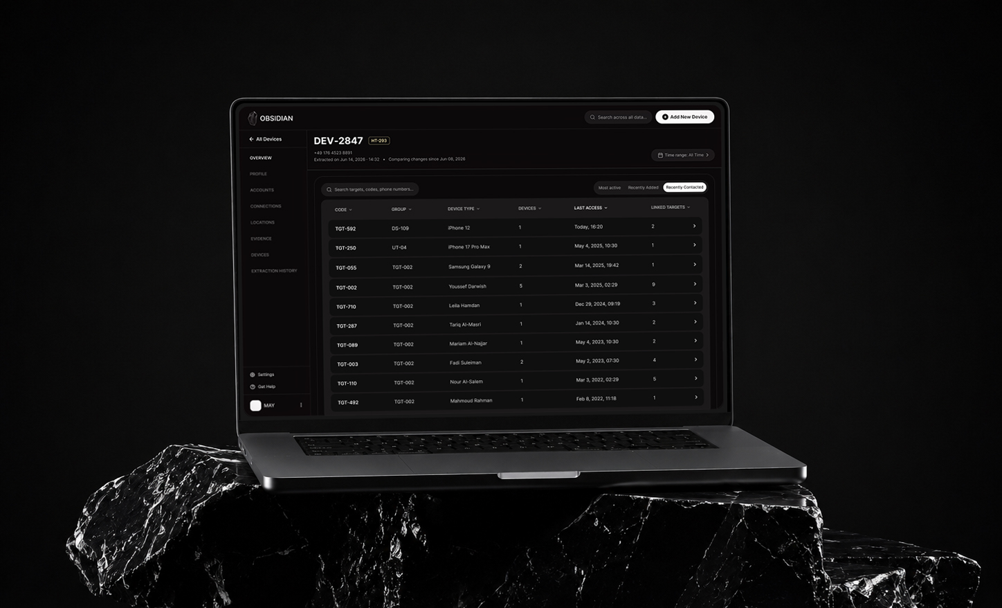 Laptop displaying a dark-themed app interface listing devices with codes, groups, types, and last access times.