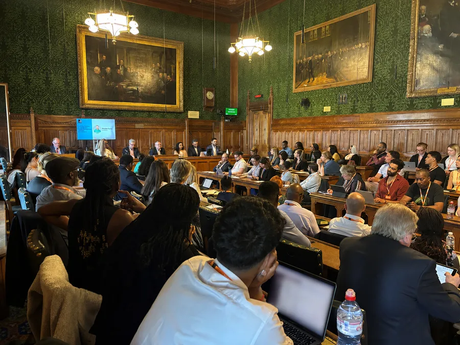 Cross-sector group in a formal Parliament room