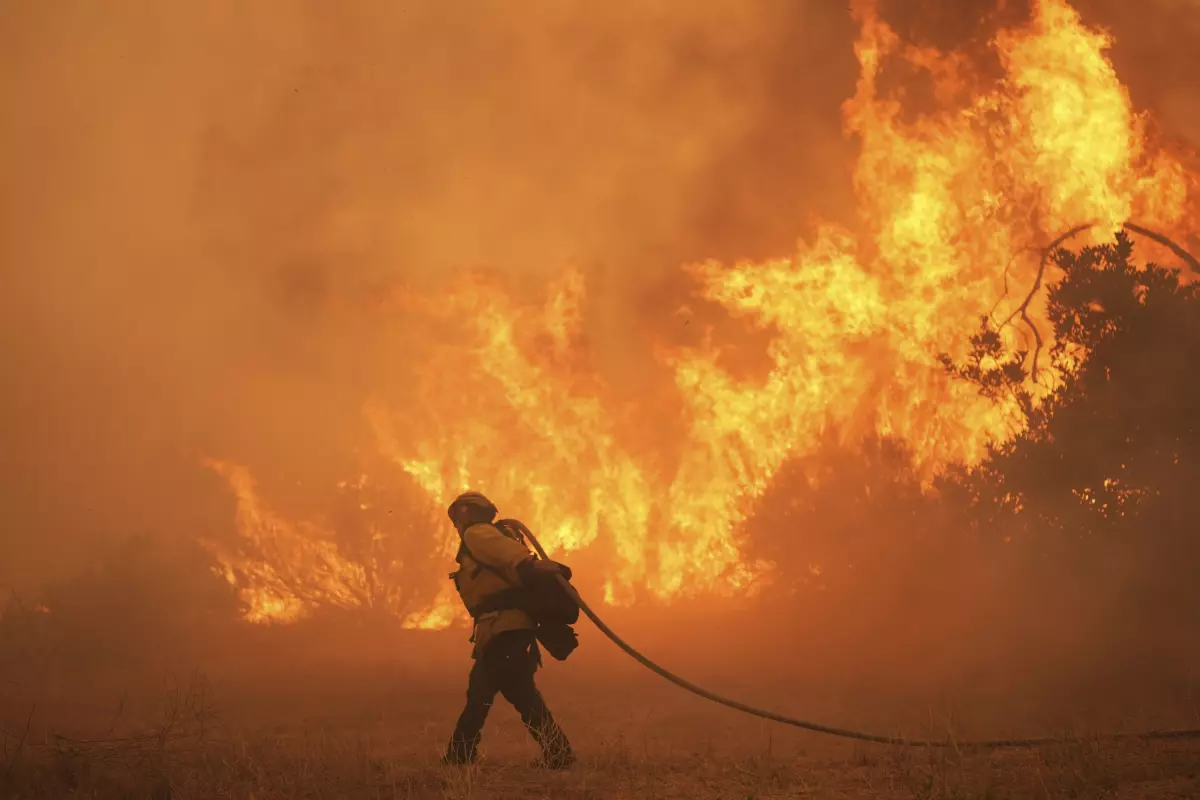 A firefighter battles the Canyon Fire in August in Hasley Canyon, Calif. As temperatures rise with human-caused climate change, wildfire risk is getting worse.