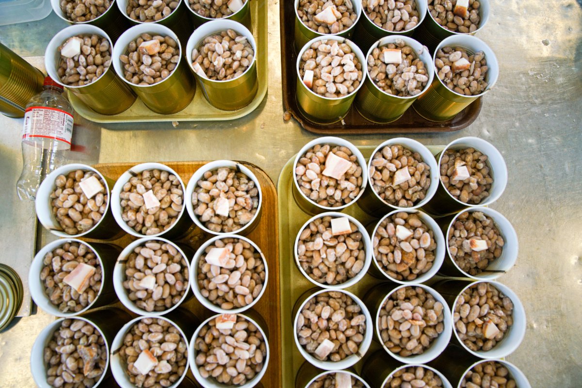 Filled cans of beans with chunks of hog jowl await their turn in the water bath. (Photo credit: Rinne Allen)