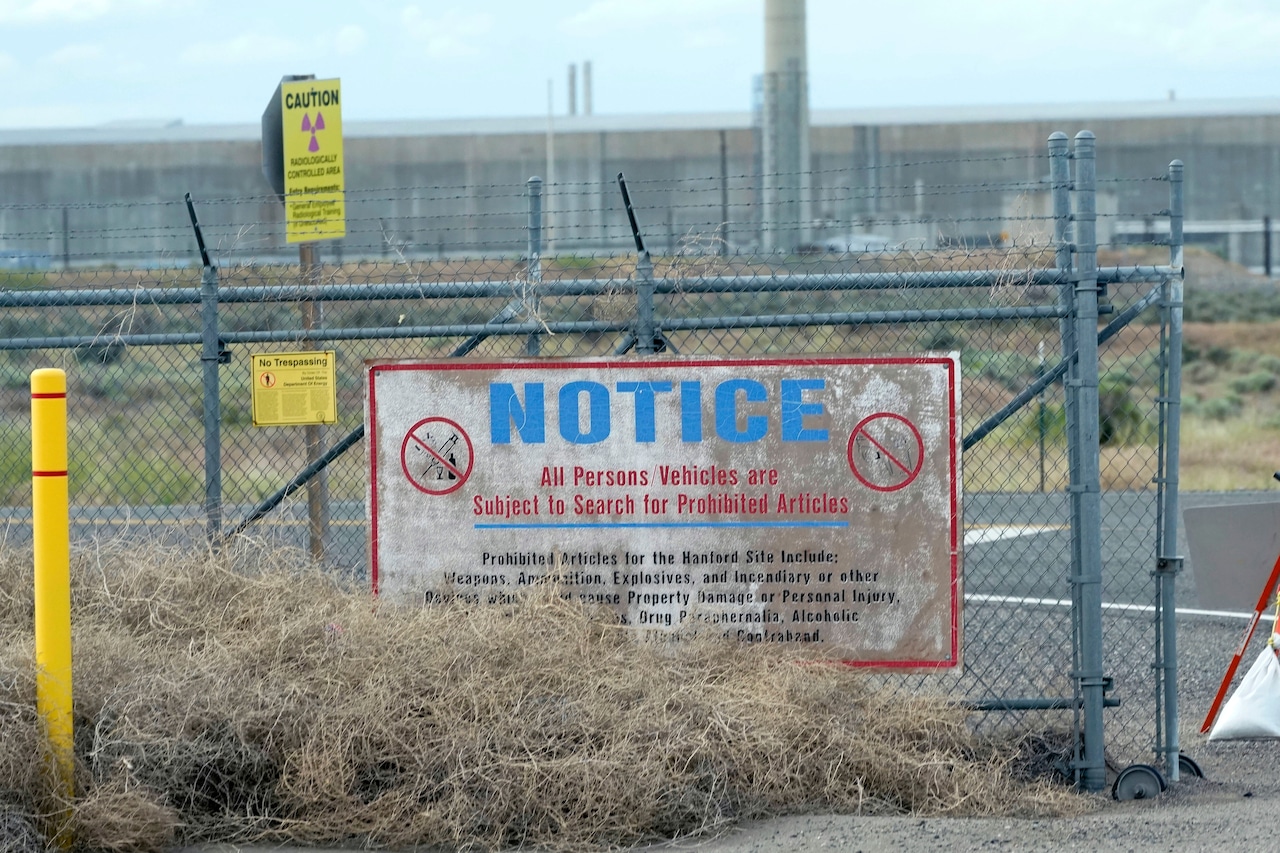 A dirty sign five or six feet wide says, "Are person's vehicles subject to search for prohibited articles"