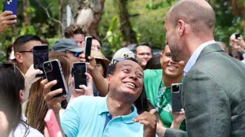 PA Media The Prince of Wales poses for pictures with members of the public during a Welcome to Rio event at Sugarloaf Mountain, in Rio de Janeiro