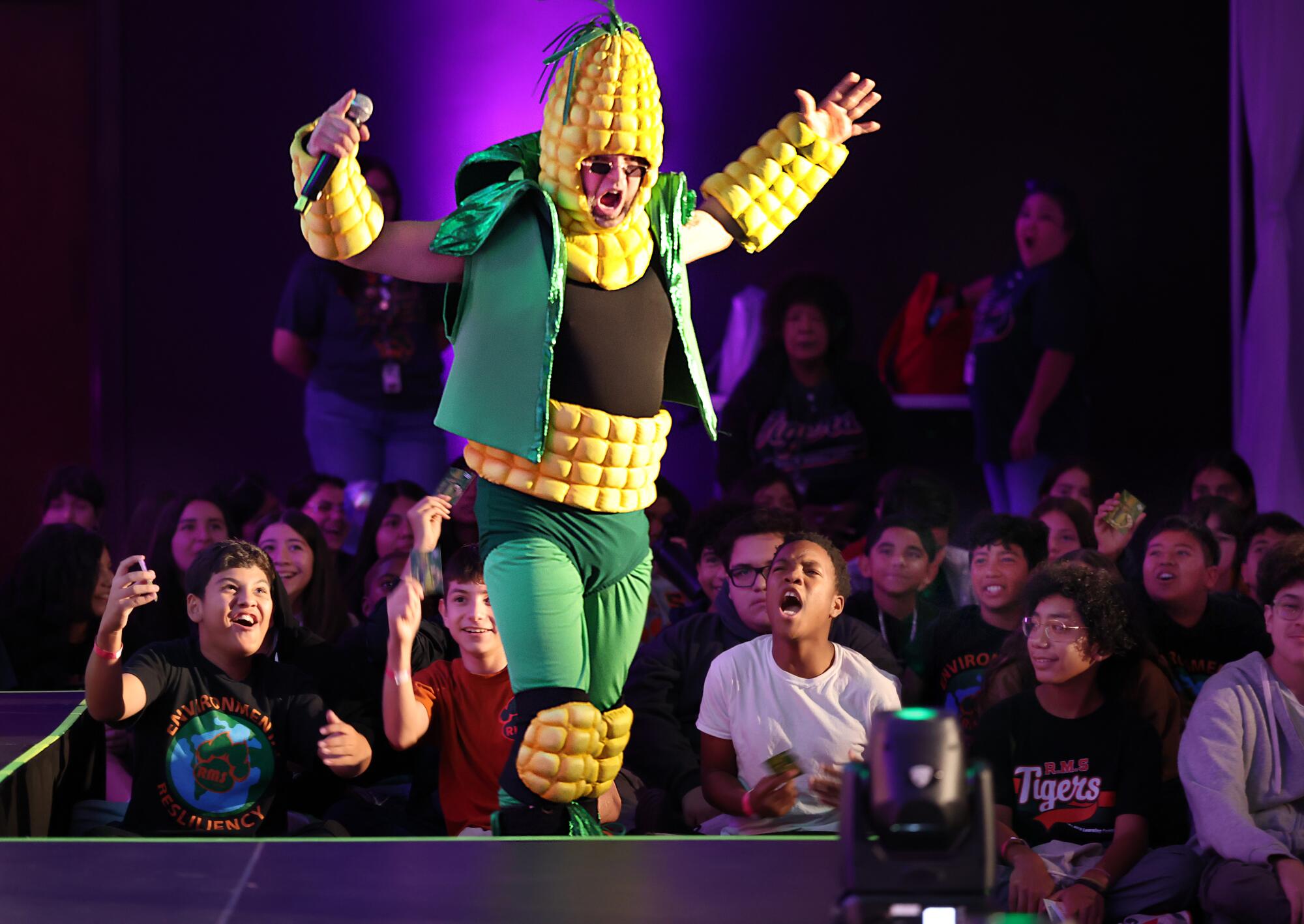 Students watch the energy superhero character "Ethanol" dressed as a corn cob at the Future Green Leaders Summit.