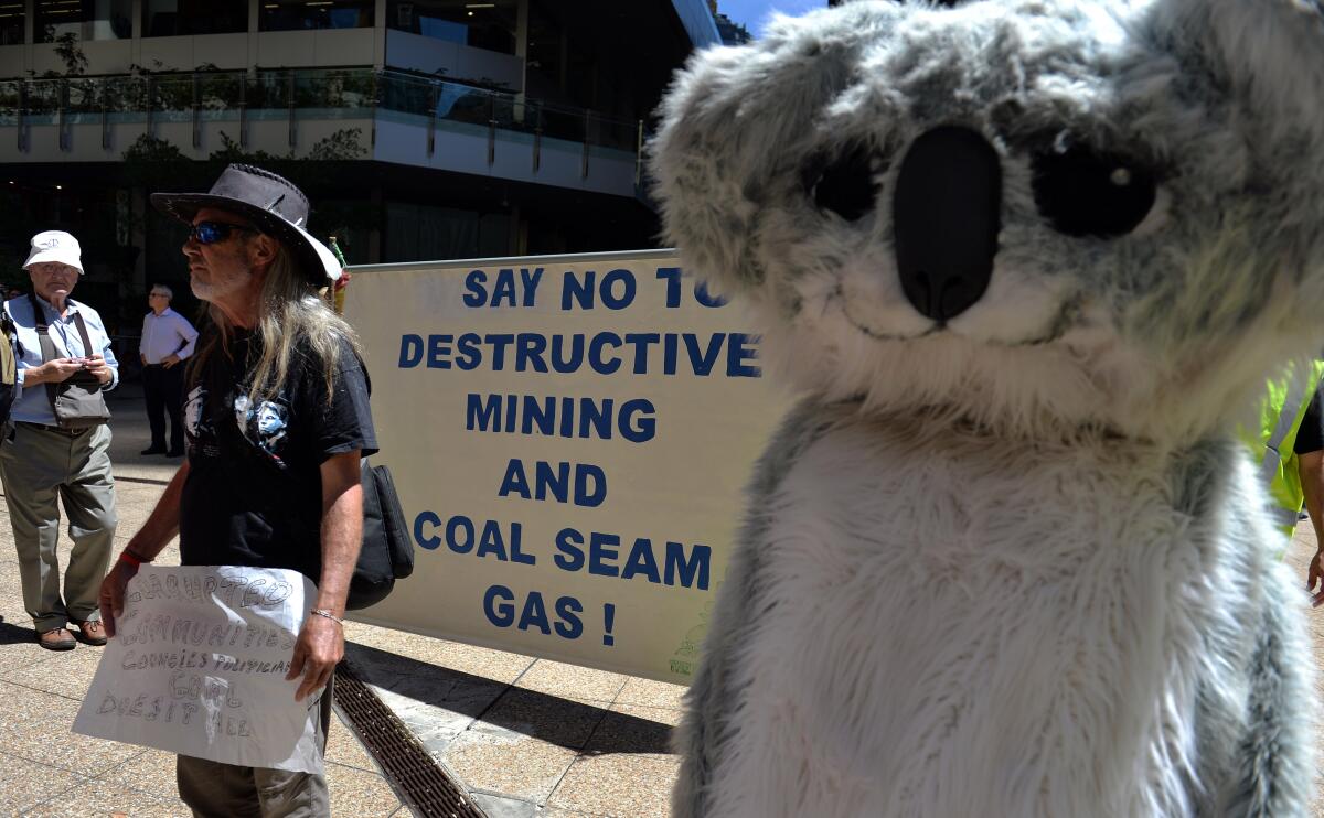 Protesters hold placards and banners during a rally against Whitehaven Coal in Sydney in 2014. 
