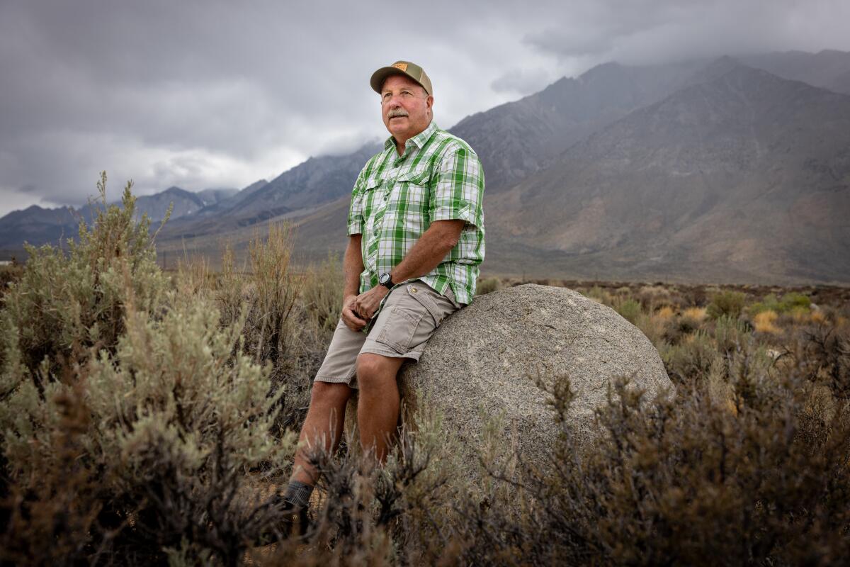 Brian Tillemans sits near Mt. Tom, in an area where bighorn visit.