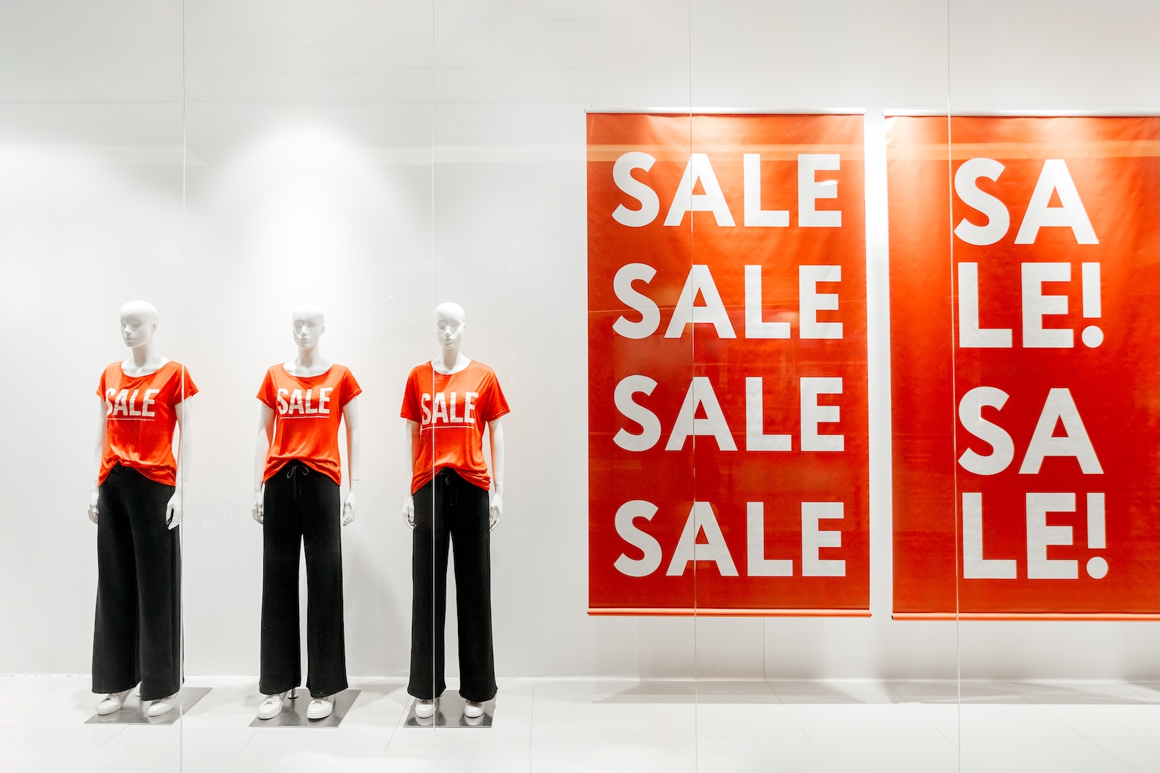 Store window display with sale, discount and mannequins