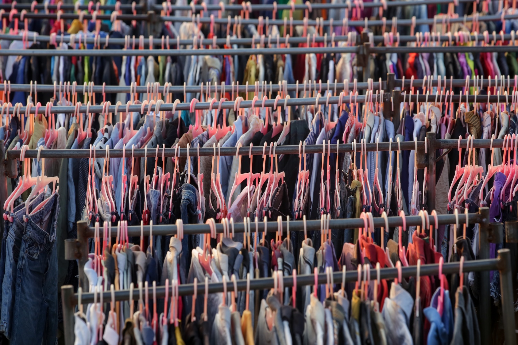 rows of clothes on pink hangars