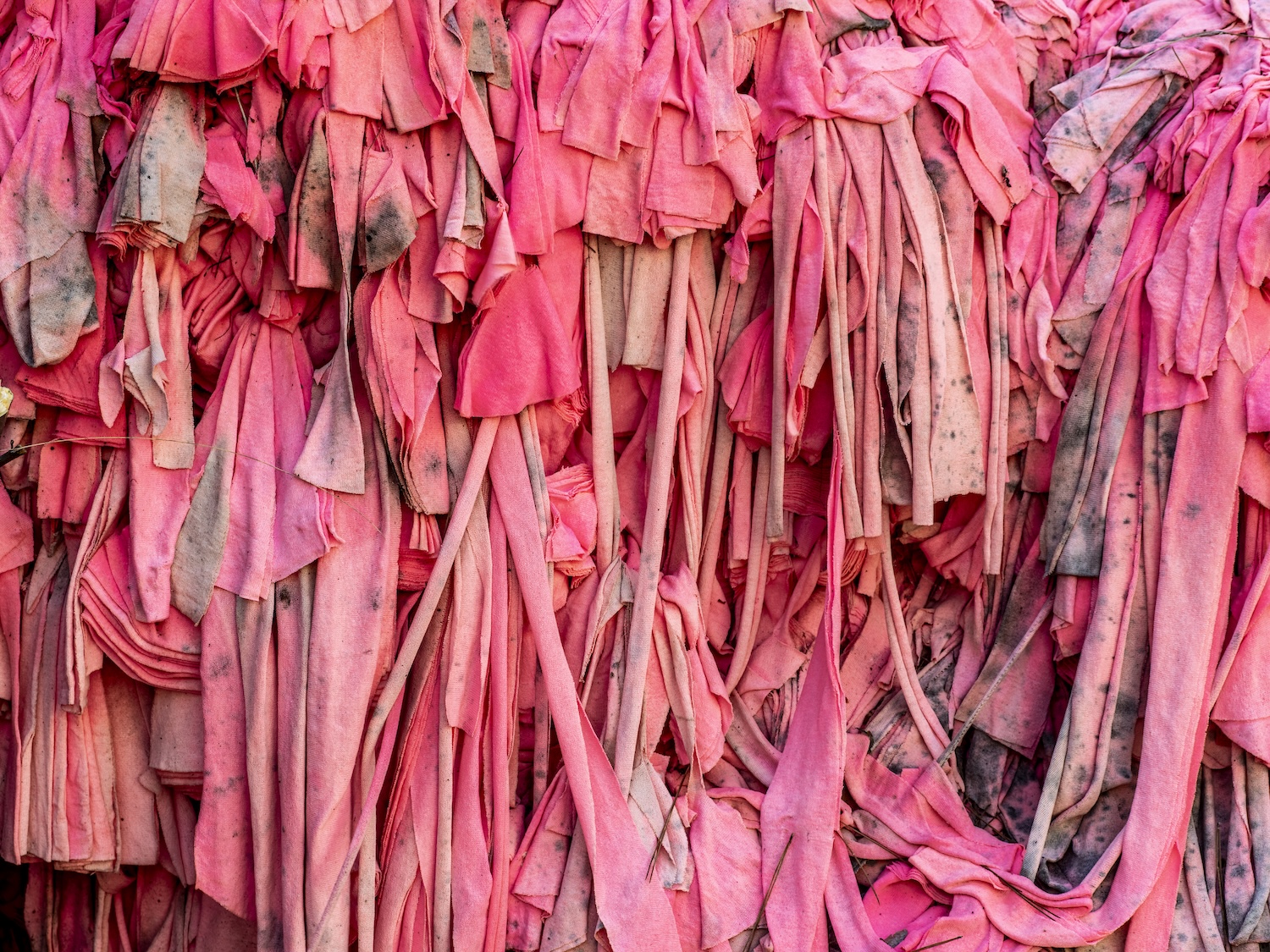 A pile of stained and shredded pink clothing and textiles