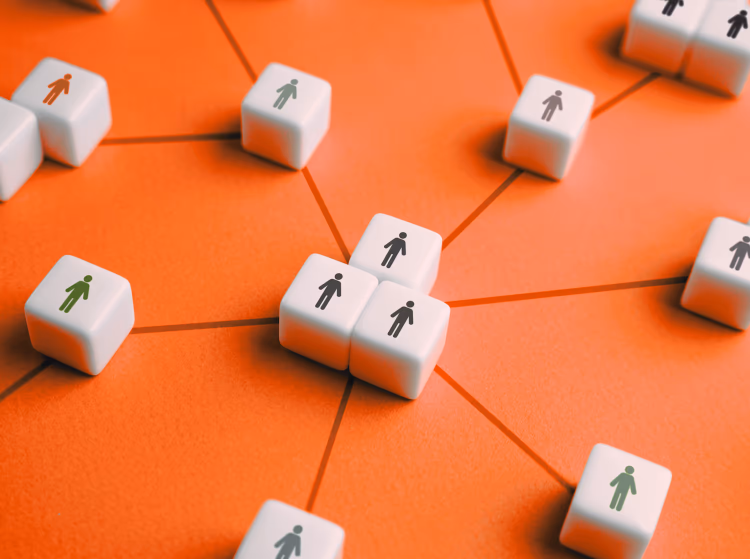 White cubes with people icons connected by orange lines, representing a network or community.