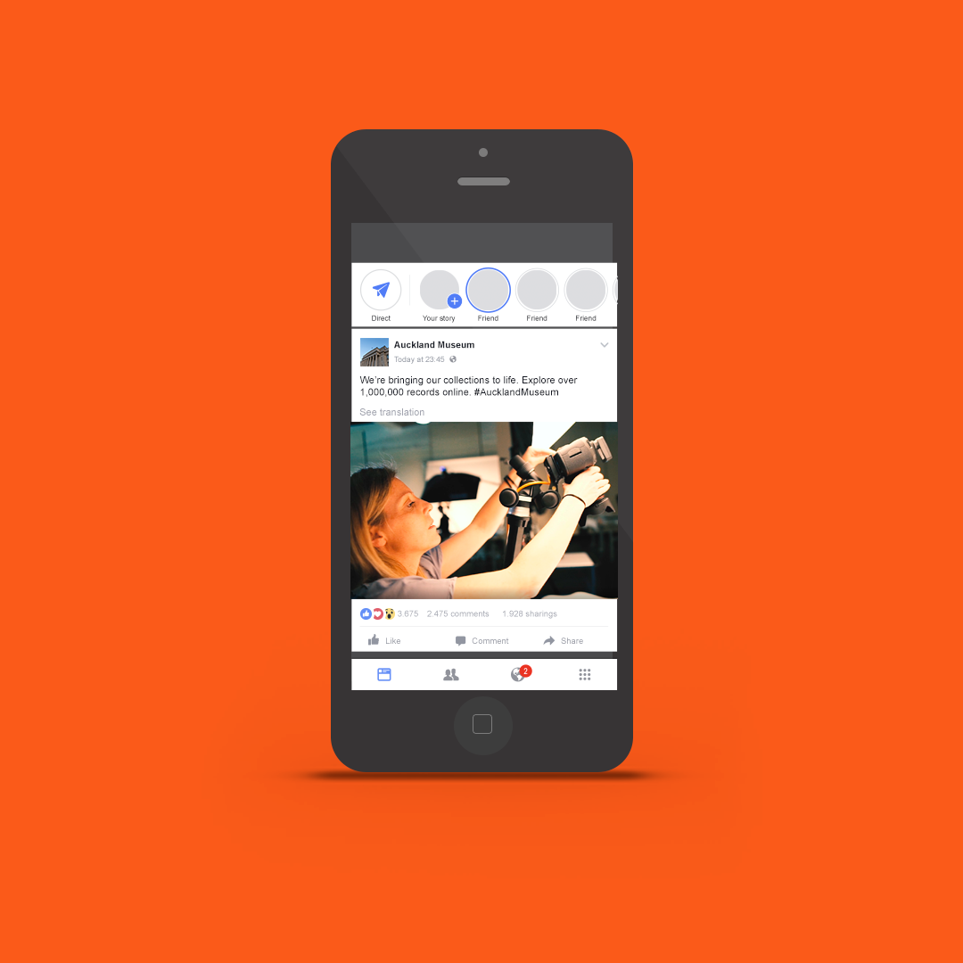 Mobile phone mockup featuring a photography campaign creative for the Auckland Museum collections online campaign showing a collections photographer at work.