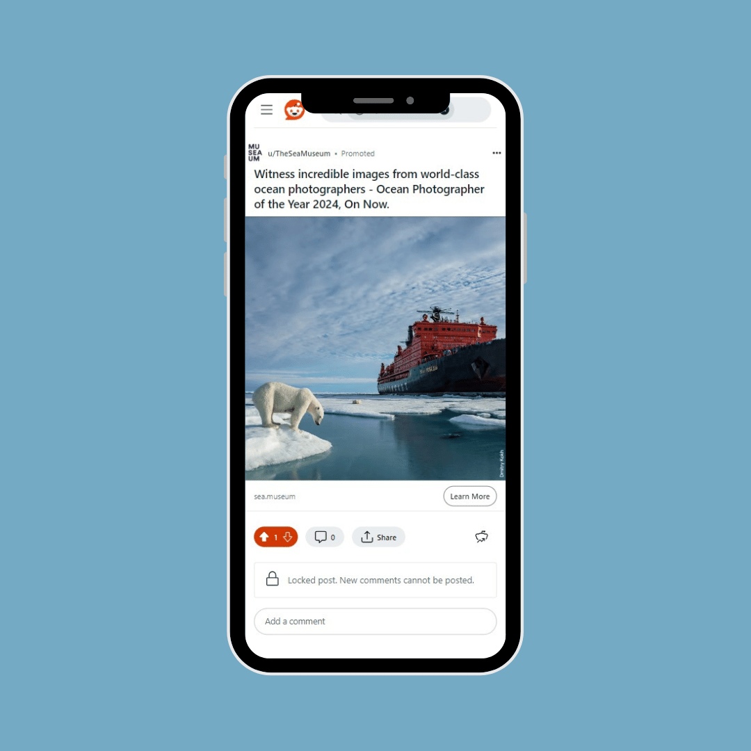 Phone mockup of Reddit advertising for Ocean Photographer of the Year image features Polar Bear and ice breaker ship