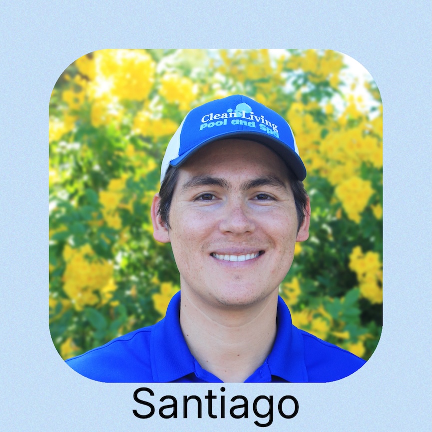 A person in a blue polo shirt stands by a serene water 