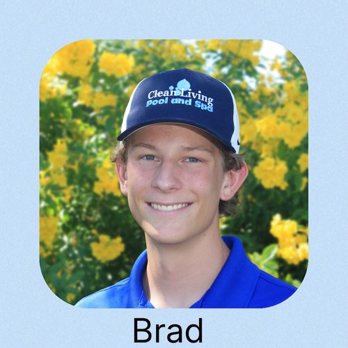 An man wearing a blue cap and shirt standing and smiling