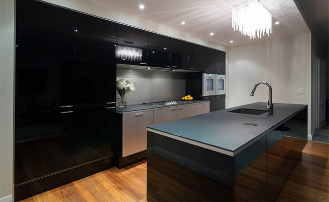 Black, glass counter top matching with black colour kitchen motif 