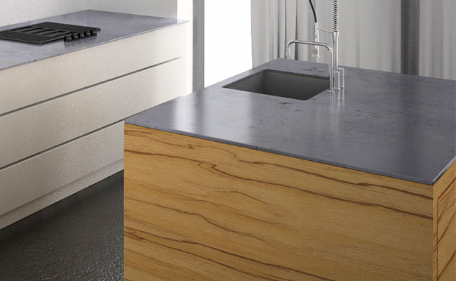 Dark grey, polished concrete benchtop contrasting against wood bench