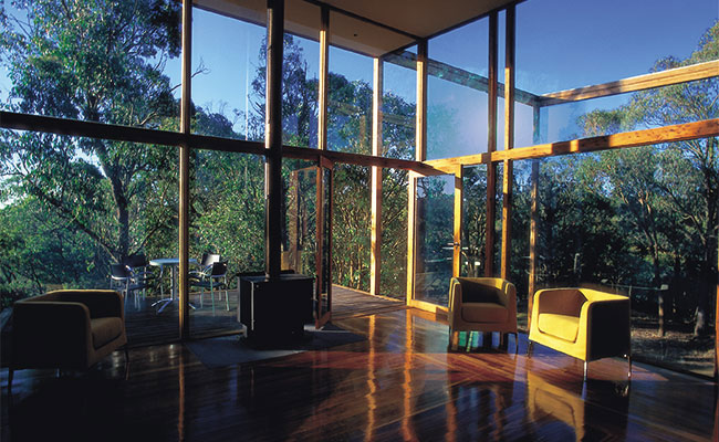 Low emission, also known as low-e glass, glass wall for living area with views complete views of outdoors.