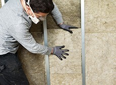 Person placing insulation into walls making a home healthier and Eco-friendly.