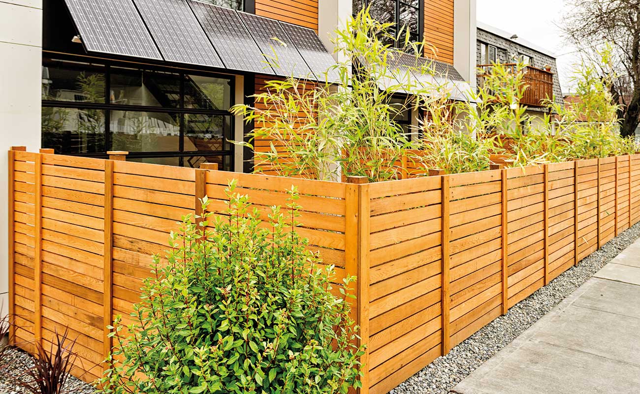 An eco-home with solar panels attached to the side of the house.