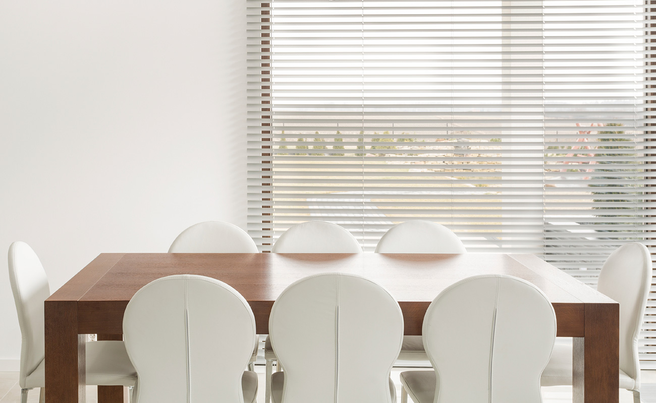 Classic white venetian blinds in dining room