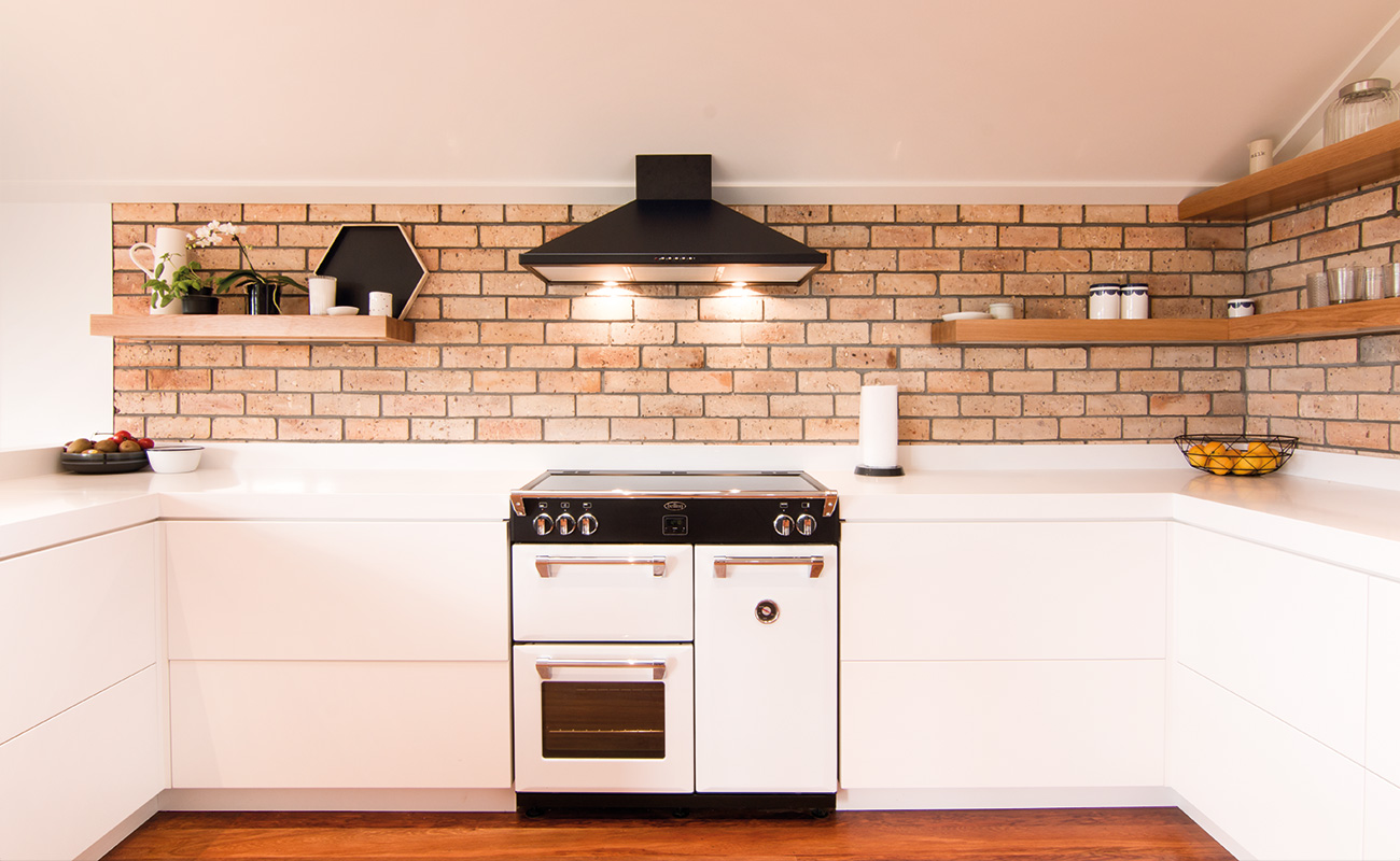Renovated kitchen with exposed brick wall feature
