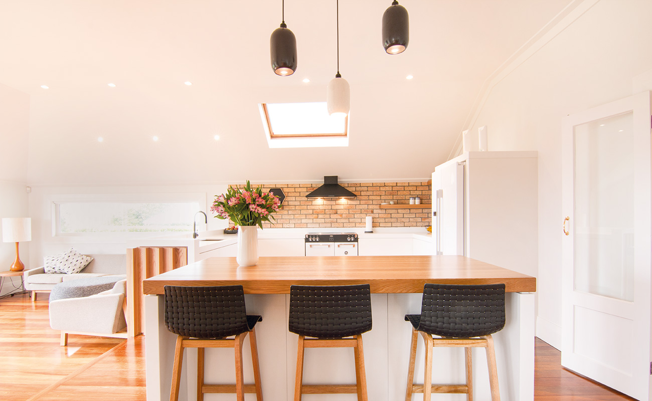 Kitchen island in renovated kitchen and open-plan lounge