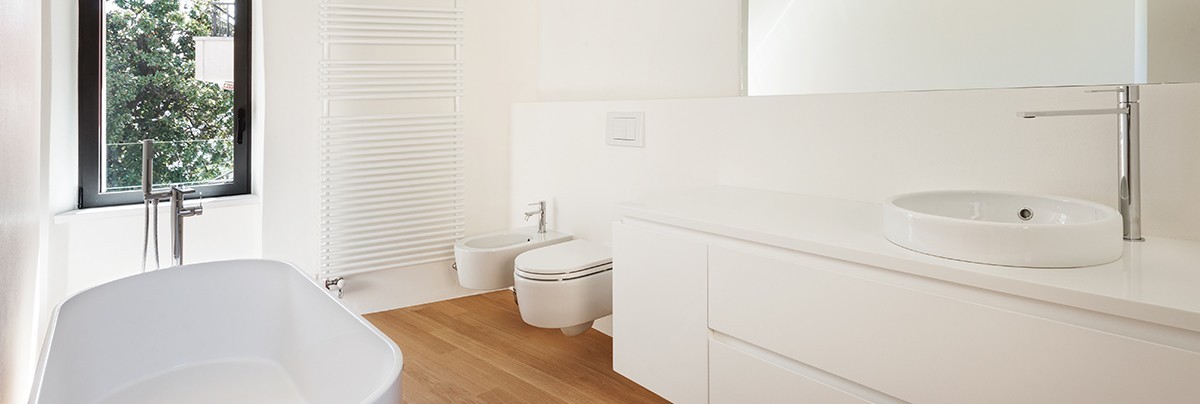 A bathroom with white paint wall and wooden floor