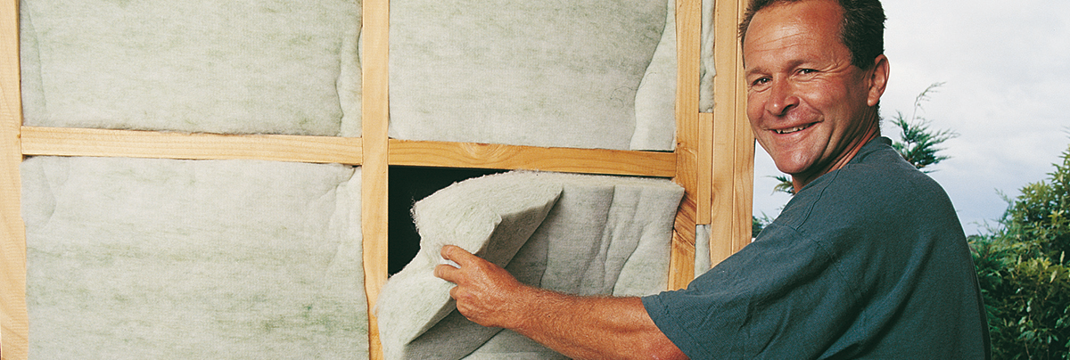 Man installing environmentally friendly home insulation