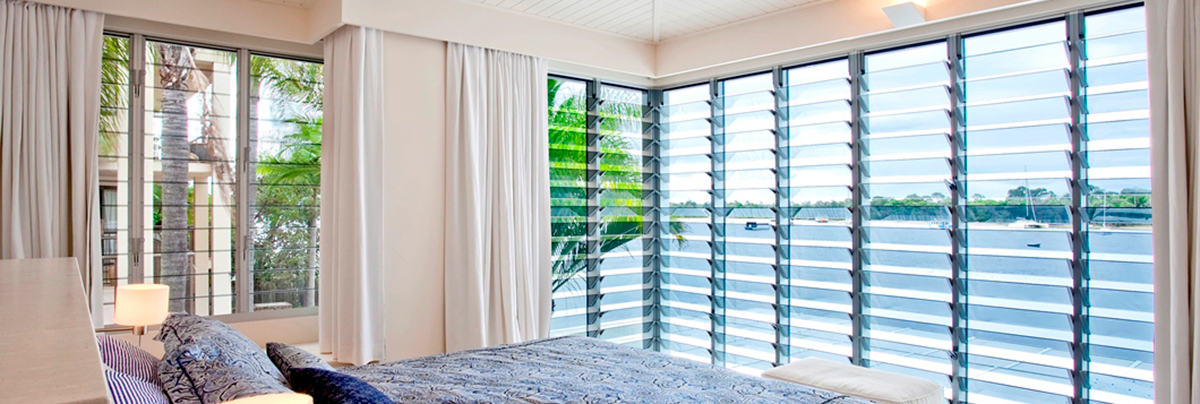 Breezeway Louvre window in white double bedroom, facing the bay.