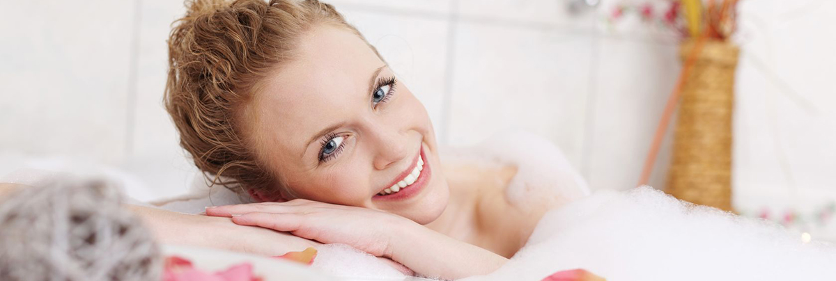 Women bathing in tub using a healthy hot water system