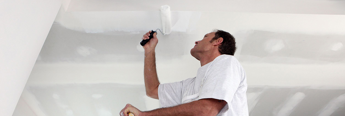 Man reparing a Pinex softboard ceiling