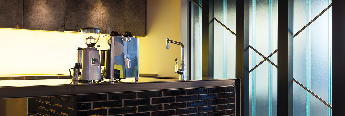Lightly tinted teal glass kitchen wall