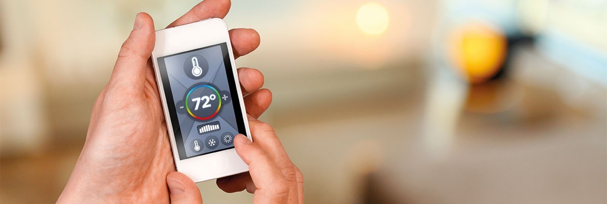 Man using a smartphone to control his home temperature